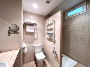 a bathroom with a toilet and a sink and a shower at Hostal Apolo in Barcelona