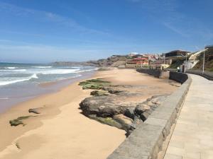 a view of a beach with rocks and the ocean at West Terrace House - Ocean View in Lourinhã