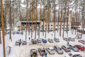 un parking avec des voitures garées dans la neige dans l'établissement Tartumaa Tervisespordikeskus, à Uderna