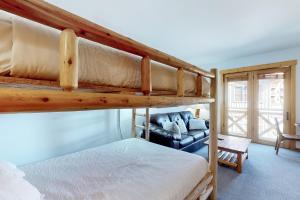 a bedroom with two bunk beds and a couch at Tucker Mountain Lodge 307b in Copper Mountain