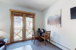 a room with a table and chairs and a window at Tucker Mountain Lodge 307b in Copper Mountain
