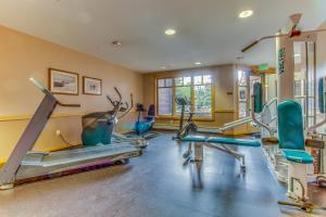 a gym with several tread machines in a room at Tucker Mountain Lodge 307b in Copper Mountain