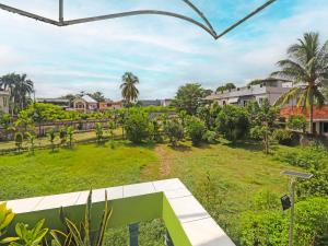 a view of the garden from the balcony of a house at OYO 2899 Ardilia Bandara Syariah in Jambi