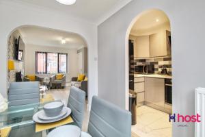 a kitchen and living room with a table and chairs at Host Liverpool - Cosy Family Home, Parking, Liverpool in West Derby