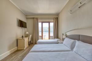 Postel nebo postele na pokoji v ubytování Hotel Bazzoni