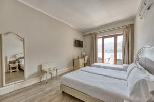 Postel nebo postele na pokoji v ubytování Hotel Bazzoni
