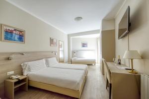 Postel nebo postele na pokoji v ubytování Hotel Bazzoni