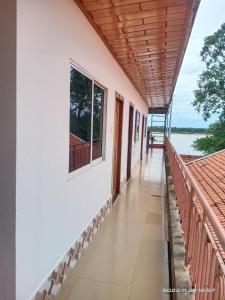 a balcony of a house with a view of the water at Silver Dolphin Guesthouse & Restaurant in Kratie
