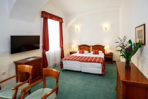 a hotel room with a bed and a table and chairs at Szidónia Castle in Röjtökmuzsaj +34 photos