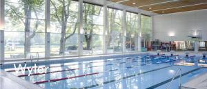 a large swimming pool with a large window at Evi's Home Hotel & Apartments in Bern