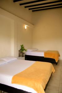 Un pat sau paturi într-o cameră la Finca Hotel Loma Verde