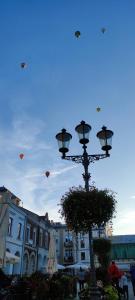 a street light with kites flying in the sky at The Old Townhouse in Krosno