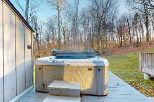 a hot tub sitting on the porch of a house at Suntec Getaway in Dover