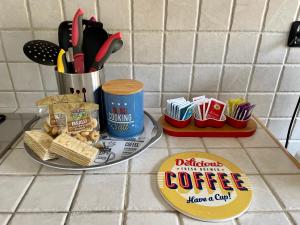 a counter with a cup of coffee and utensils at Parvis home in Brindisi