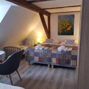 a bedroom with two beds in a attic at Pokoje Gościnne Art- Dworek in Kudowa-Zdrój