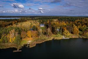 an aerial view of a house on an island in the water at Łęgucki Młyn in Gietrzwałd