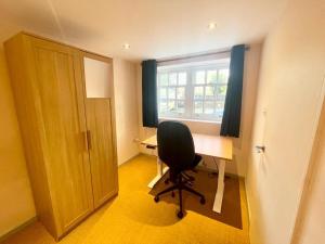 a room with a desk and a chair and a window at Richmond House (9A) by Staytor Accommodation in Exeter