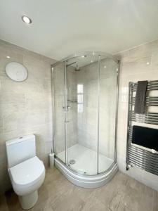 a bathroom with a glass shower and a toilet at Richmond House (9A) by Staytor Accommodation in Exeter