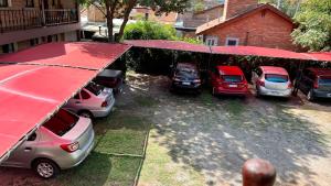 a group of cars parked in a parking lot at Apart Hotel Nonquen in Merlo