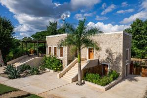 a house with a palm tree in the front yard at Destino Mío by AKEN Soul 