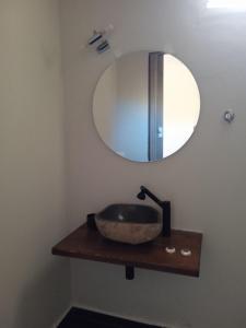 a bathroom with a sink and a mirror on a wall at Breakfast & Snacks, 2bedrooms 2bathrooms House in Kato Zachlorou