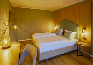 a bedroom with a large white bed in a room at Hotel Kammweg in Grossbreitenbach