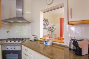 a kitchen with a sink and a stove top oven at Vila Bela Nova Acácias 22 in Luz +48 photos