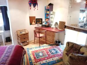 a room with a desk and a chair and a table at François Bevort ITIVAL in Broquiès