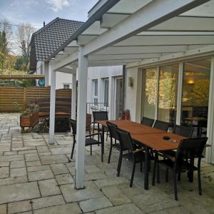 a patio with a wooden table and chairs at Haus Hillebrand in Rheinbreitbach