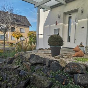 a stone retaining wall in front of a house at Haus Hillebrand in Rheinbreitbach +10 photos