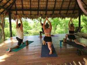 a group of people doing yoga in a pavilion at Popoyo Surfcamp in Popoyo