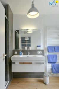 a bathroom with a sink and a mirror at Haus Inselrose Ferienwohnung Wildrose in Juist