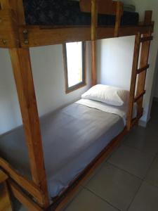 a bedroom with a bunk bed with white sheets at La Maruca in El Hoyo