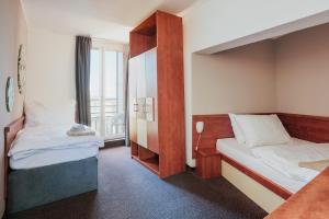 Voodi või voodid majutusasutuse Atrium Hotel - Family friendly toas