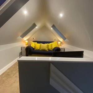 a living room with a couch with yellow pillows at Stylish 1st Floor flat Free Parking 2mins from Junction 48A1m in Boroughbridge
