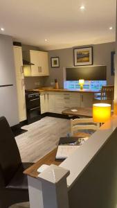 a kitchen with a table and a dining room at Stylish 1st Floor flat Free Parking 2mins from Junction 48A1m in Boroughbridge