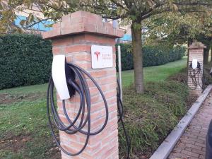 a brick pillar with a phone in a park at Crowne Plaza Milan Malpensa Airport, an IHG Hotel in Case Nuove