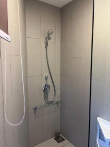 a shower with a shower head in a bathroom at The Landmark Comfort Relax Spacious Sea View By IZ in Tanjong Tokong