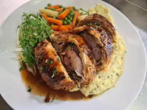 un piatto di alimenti a base di carne e purè di patate e verdure di Formanka Hotel & Camp a Hustopeče