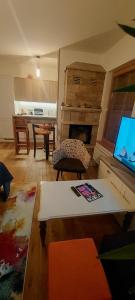 a living room with a tv and a living room with a table at Apartment Babin Do in Bjelašnica