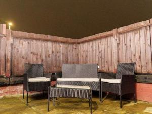 a group of chairs and a table in front of a wall at Excel House Serviced Apartments in Leeds