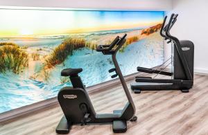 a room with two exercise bikes in front of a wall at Mercure Bordeaux Centre Ville in Bordeaux