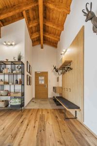 a gym with a bench in a room with wooden ceilings at Dachstein West Apartment T4 in Russbach am Pass Gschütt