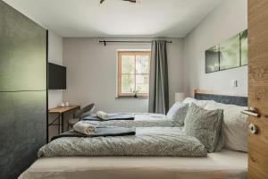 een slaapkamer met een bed, een bureau en een raam bij Dachstein West Apartment T3 in Russbach am Pass Gschütt +46 foto's