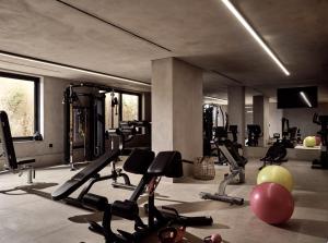 a gym with several treadmills and exercise bikes at Contessina Hotel in Tsilivi