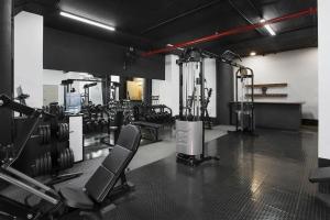 a gym with cardio equipment in a room at The Franklin Luxury Apartments in Johannesburg