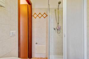 a shower with a glass door in a bathroom at Michelangelo's House in Gioiosa Marea +82 photos