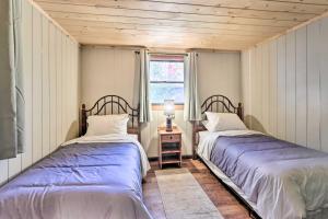 two beds in a small room with a window at Cozy Getaway Less Than 1 Mi to Cowans Gap State Park! 