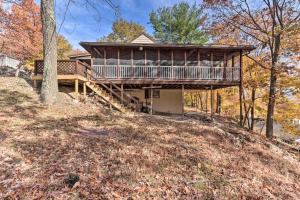 a house on a hill with a wrap around deck at Cozy Getaway Less Than 1 Mi to Cowans Gap State Park! 