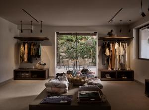 a living room with a couch and some clothes at Contessina Hotel in Tsilivi
